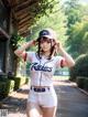 A woman in a baseball uniform is posing for a picture.